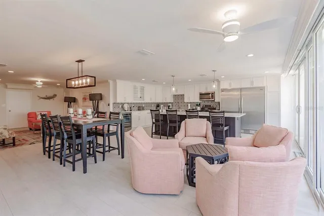 a view of a dining room with furniture and a chandelier