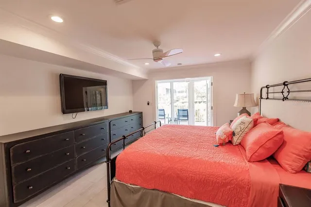 a bedroom with a bed a window and dresser