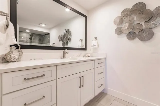 a bathroom with a double vanity sink and a mirror