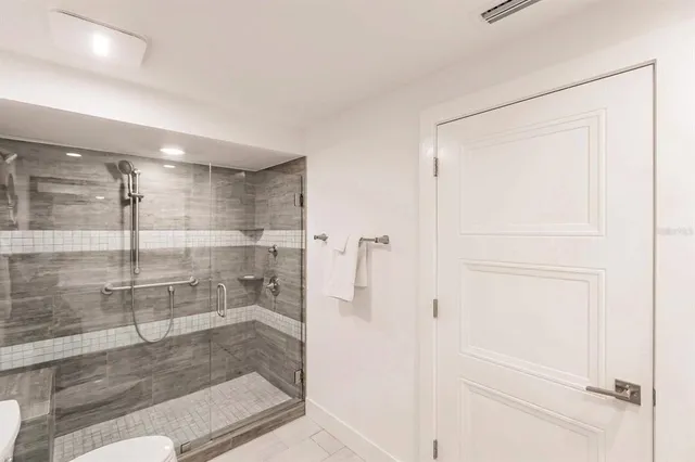 a bathroom with a glass shower door