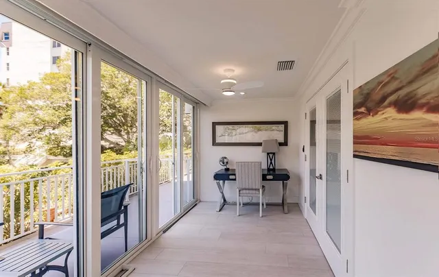 a living room with furniture and a floor to ceiling window