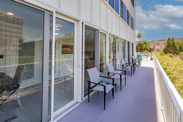 a view of balcony with wooden floor and outdoor seating