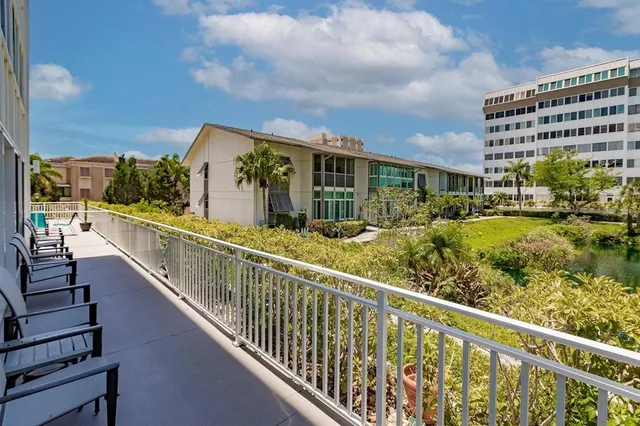 a view of balcony with wooden floor and outdoor seating