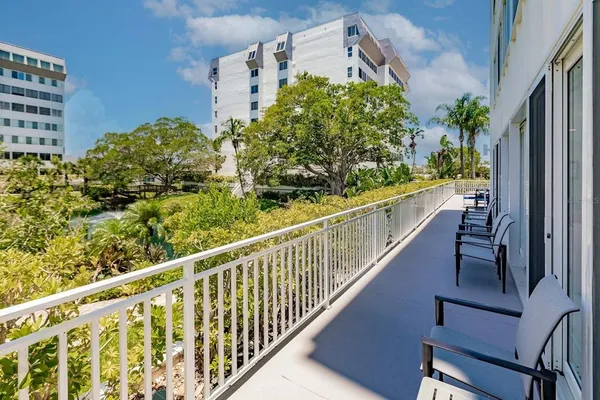 a living room with stainless steel appliances kitchen island granite countertop furniture and a rug