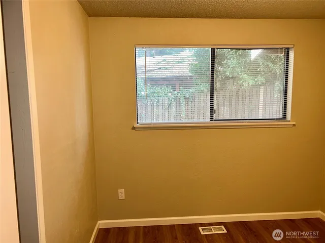 an empty room with wooden floor and closet