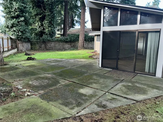 a backyard of a house with table and chairs