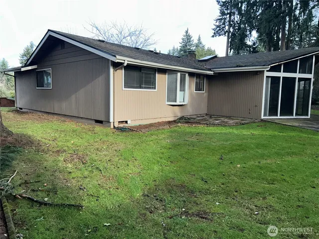 a view of backyard of house and garage