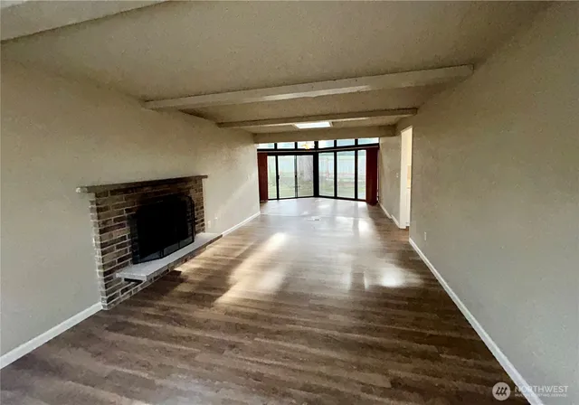 a view of an empty room and a fireplace