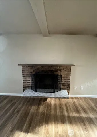 a view of fireplace and wooden floor
