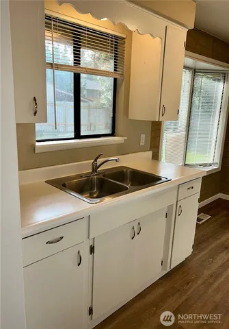 a kitchen with a stove a refrigerator and a cabinets