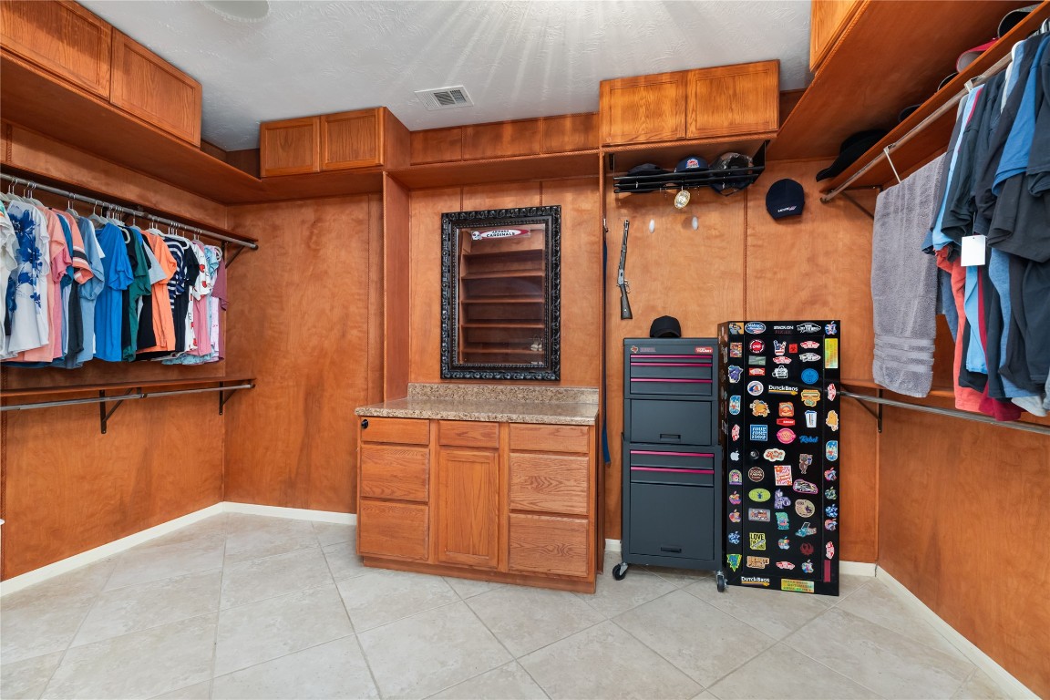 20735 Deauville Drive Spring, TX 77388 - Photo 15 of 33 A massive walk-in closet in the primary suite provides abundant space to organize clothing and accessories with ease.