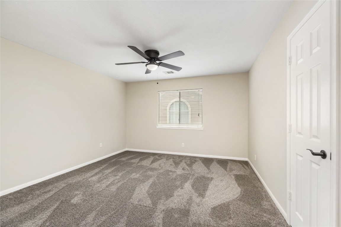 20735 Deauville Drive Spring, TX 77388 - Photo 21 of 33 This bright secondary bedroom, like the rest of the home, is filled with natural light—creating a warm and inviting space for rest, study, or play.