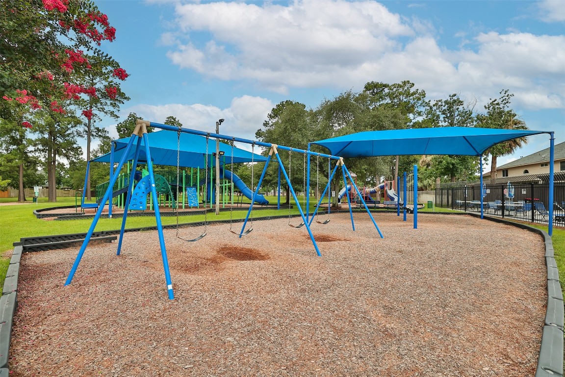 20735 Deauville Drive Spring, TX 77388 - Photo 30 of 33 The playground features a variety of play equipment thoughtfully designed for fun and safety, with much of it shaded to keep little ones cool and protected during playtime—making it a perfect spot for kids to enjoy year-round.