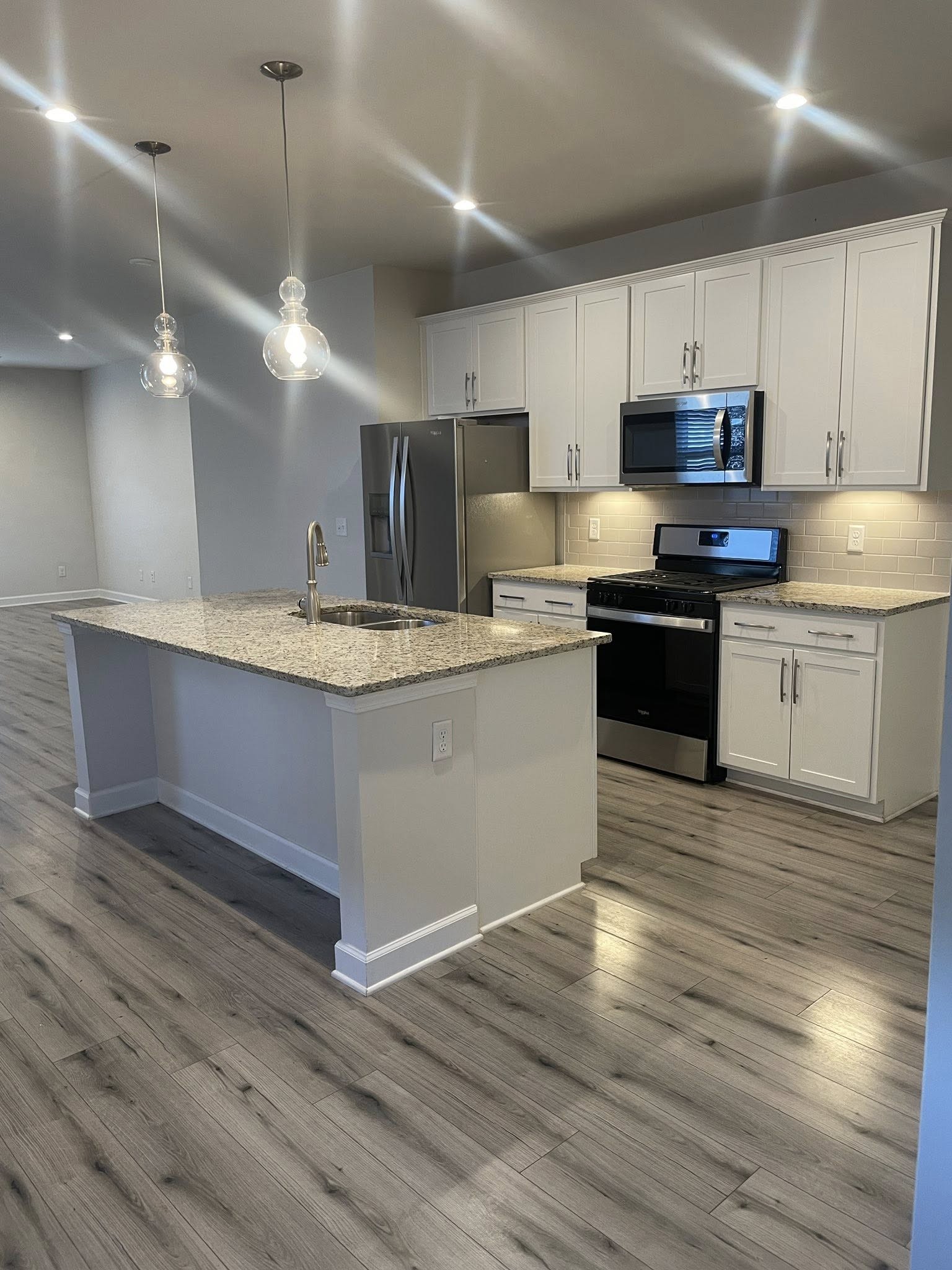 2119 Neill Lane White House, TN 37188 - Photo 3 of 16 a kitchen with stainless steel appliances granite countertop a sink a stove and a wooden floors