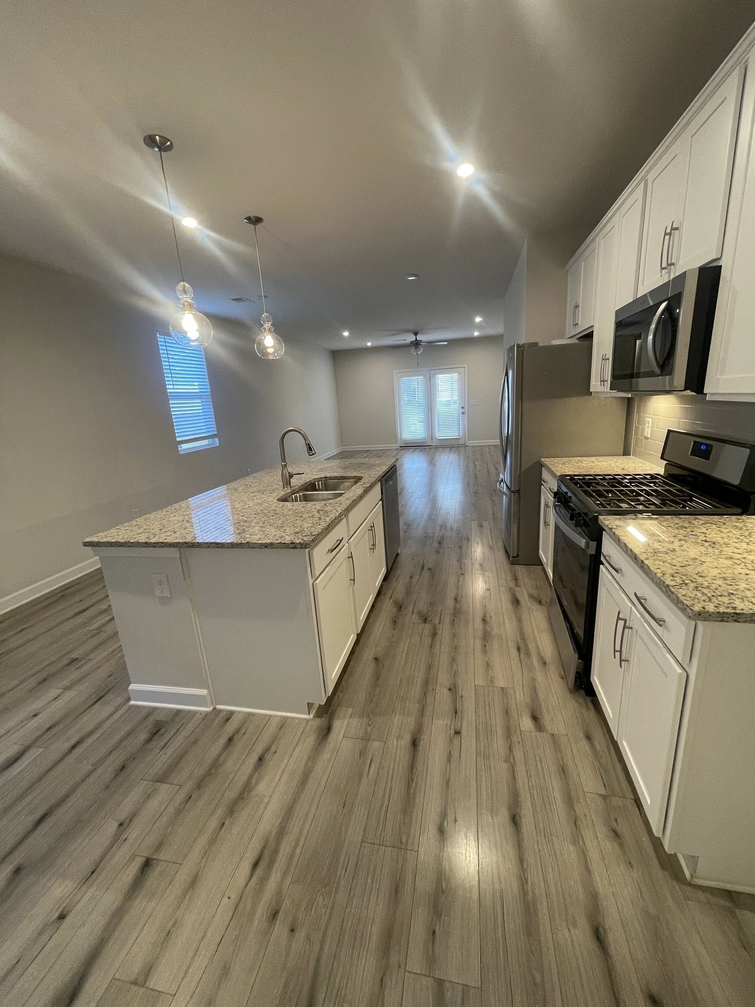 2119 Neill Lane White House, TN 37188 - Photo 4 of 16 a large kitchen with stainless steel appliances granite countertop a large counter top a stove and a wooden floors