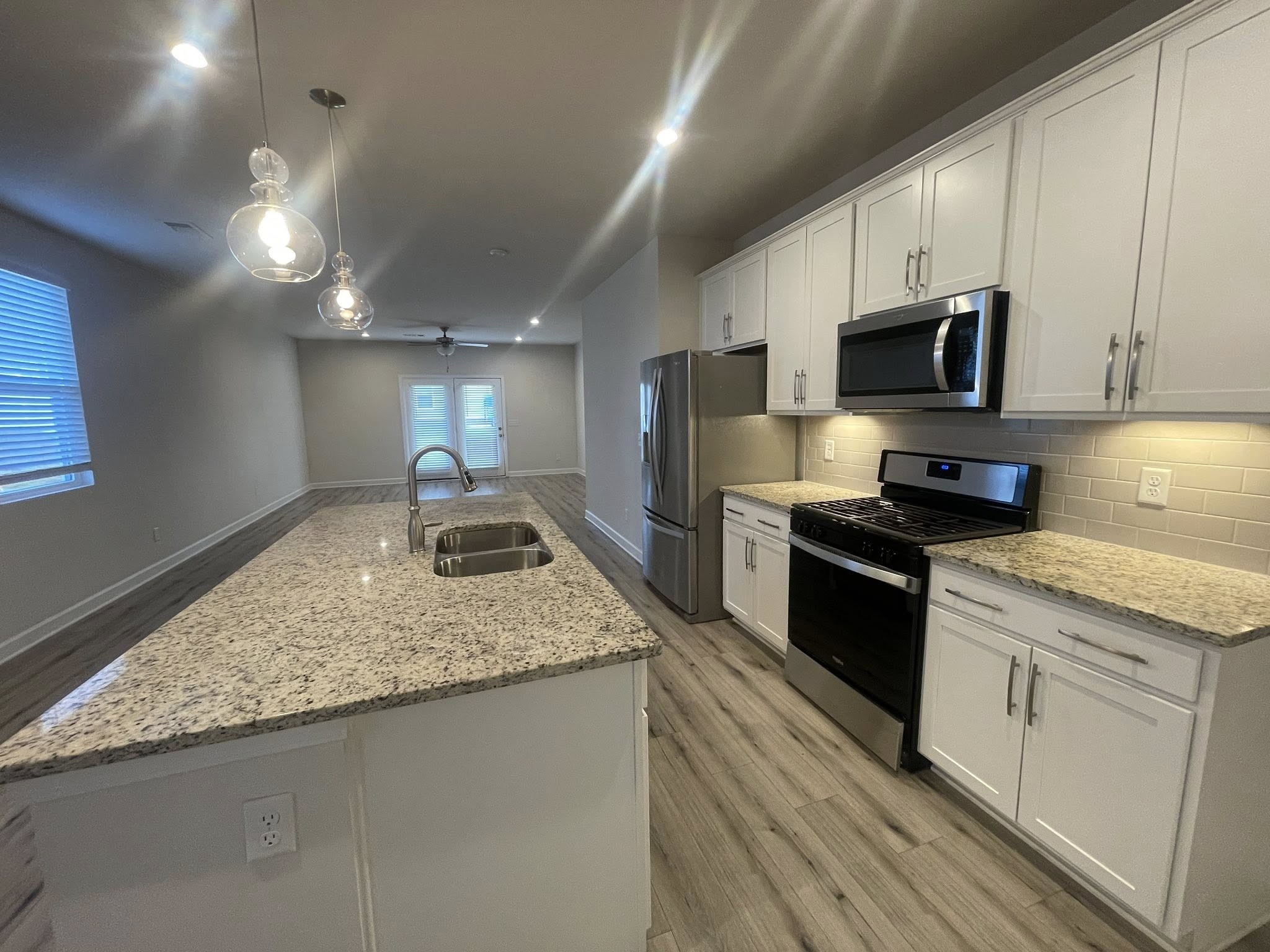 2119 Neill Lane White House, TN 37188 - Photo 6 of 16 a kitchen with granite countertop stainless steel appliances a stove microwave and sink