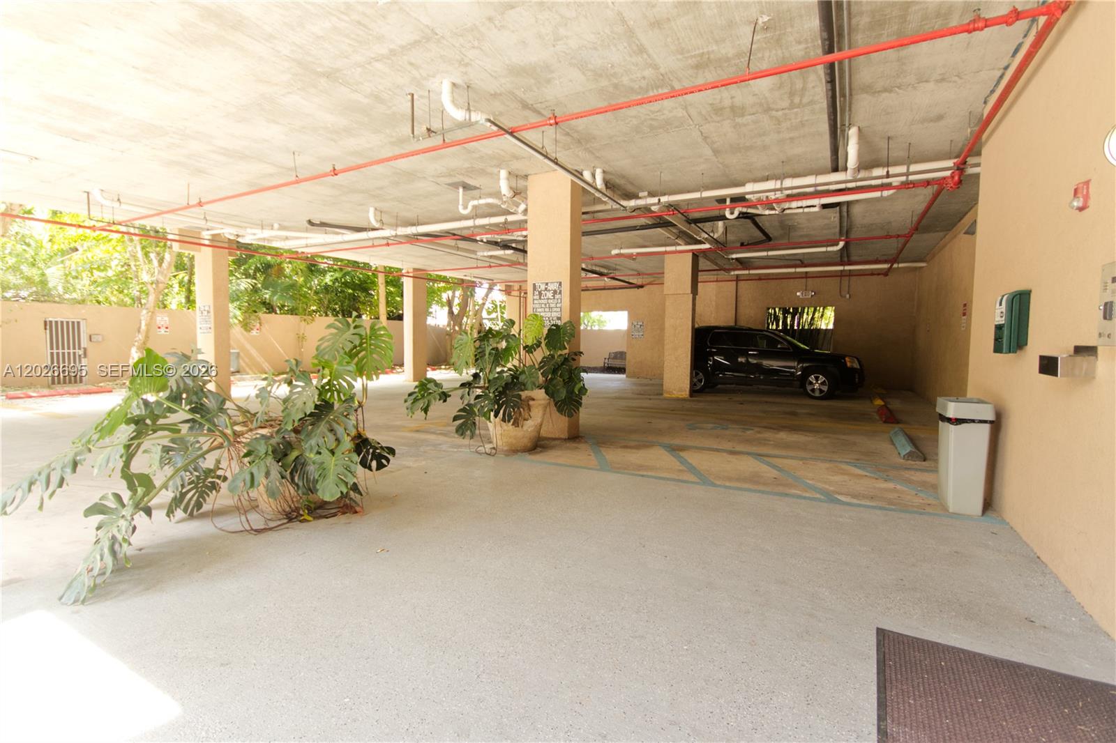 2630 Southwest 28th Street, Unit 22 Miami, FL 33133 - Photo 8 of 9 a view of a garage with couple of cars parked