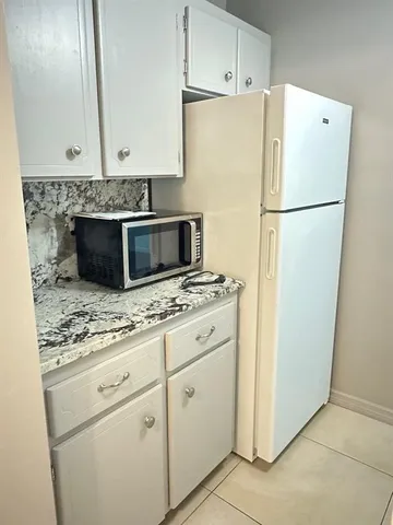 a white refrigerator freezer sitting inside of a kitchen