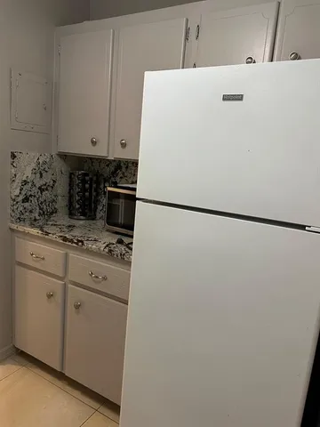 a front view of a house with swimming pool having outdoor seating