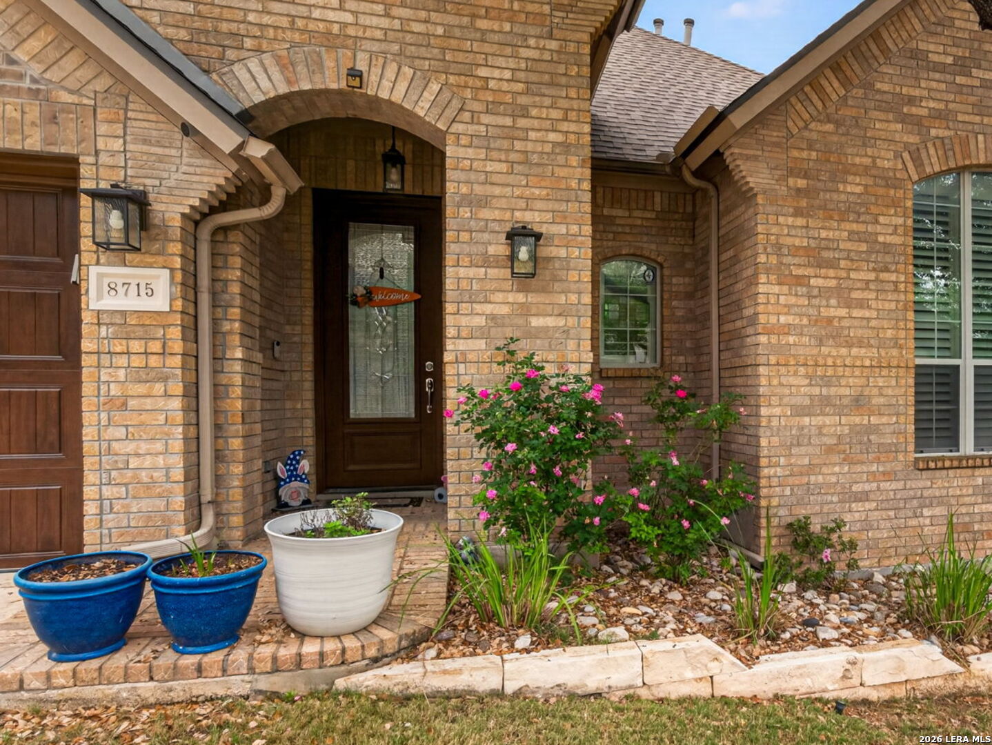 8715 Rancho De Taos Helotes, TX 78023 - Photo 3 of 40 a front view of a house with potted plants