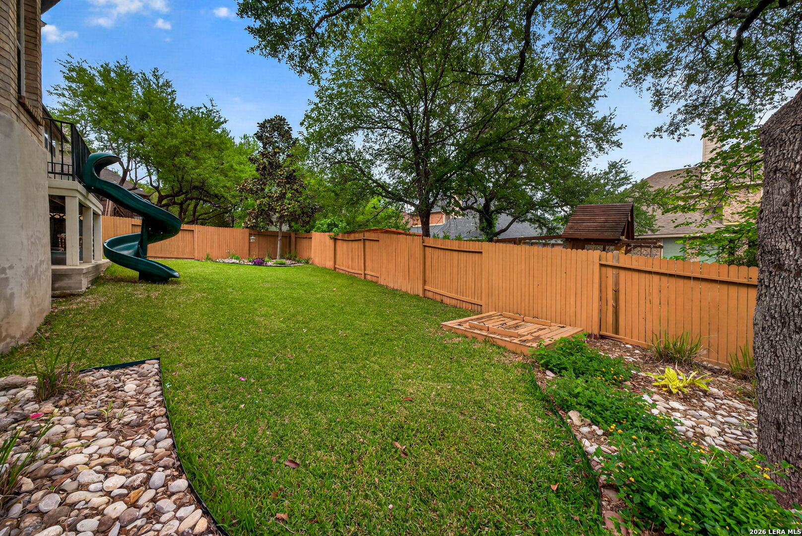 8715 Rancho De Taos Helotes, TX 78023 - Photo 39 of 40 a view of a backyard with large trees
