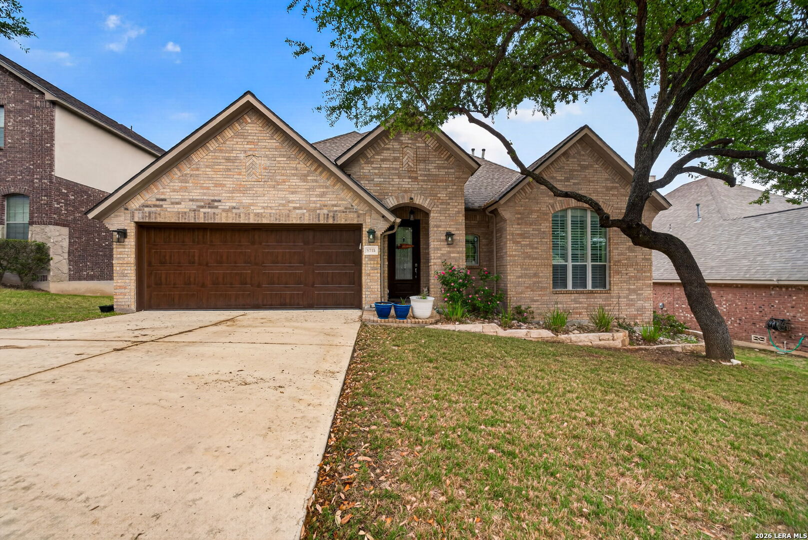 8715 Rancho De Taos Helotes, TX 78023 - Photo 5 of 40 a front view of a house with a yard and garage