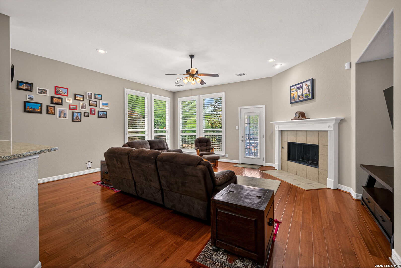 8715 Rancho De Taos Helotes, TX 78023 - Photo 9 of 40 a living room with furniture a fireplace and a flat screen tv