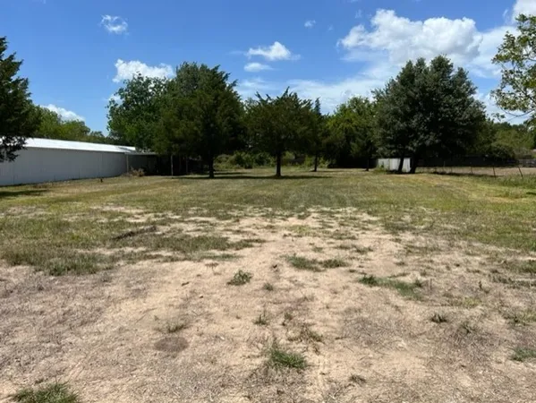 a view of field with trees in the background