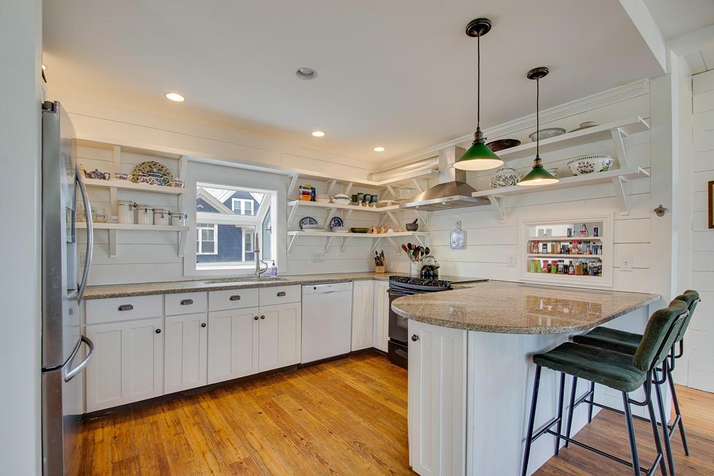 86 Pond Street Natick, MA 01760 - Photo 15 of 33 a kitchen with granite countertop cabinets a sink and a stove