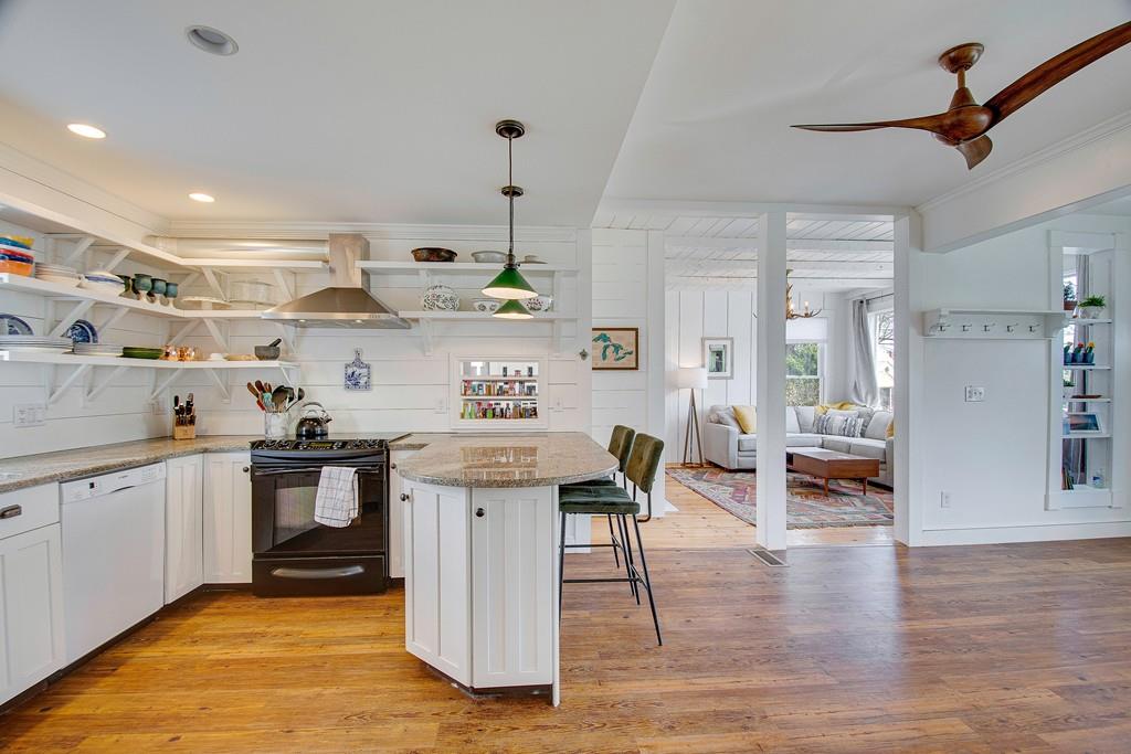 86 Pond Street Natick, MA 01760 - Photo 16 of 33 a kitchen with stainless steel appliances granite countertop a sink a stove and a wooden floor