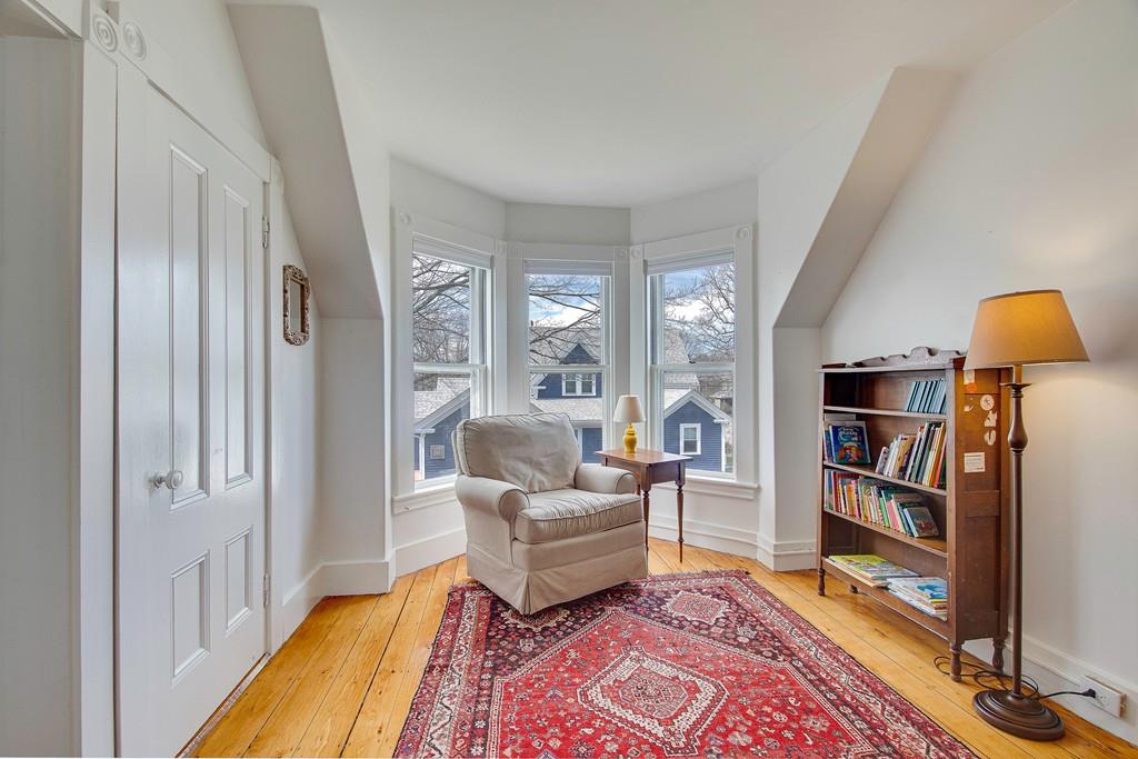 86 Pond Street Natick, MA 01760 - Photo 24 of 33 a living room with furniture and a book shelf