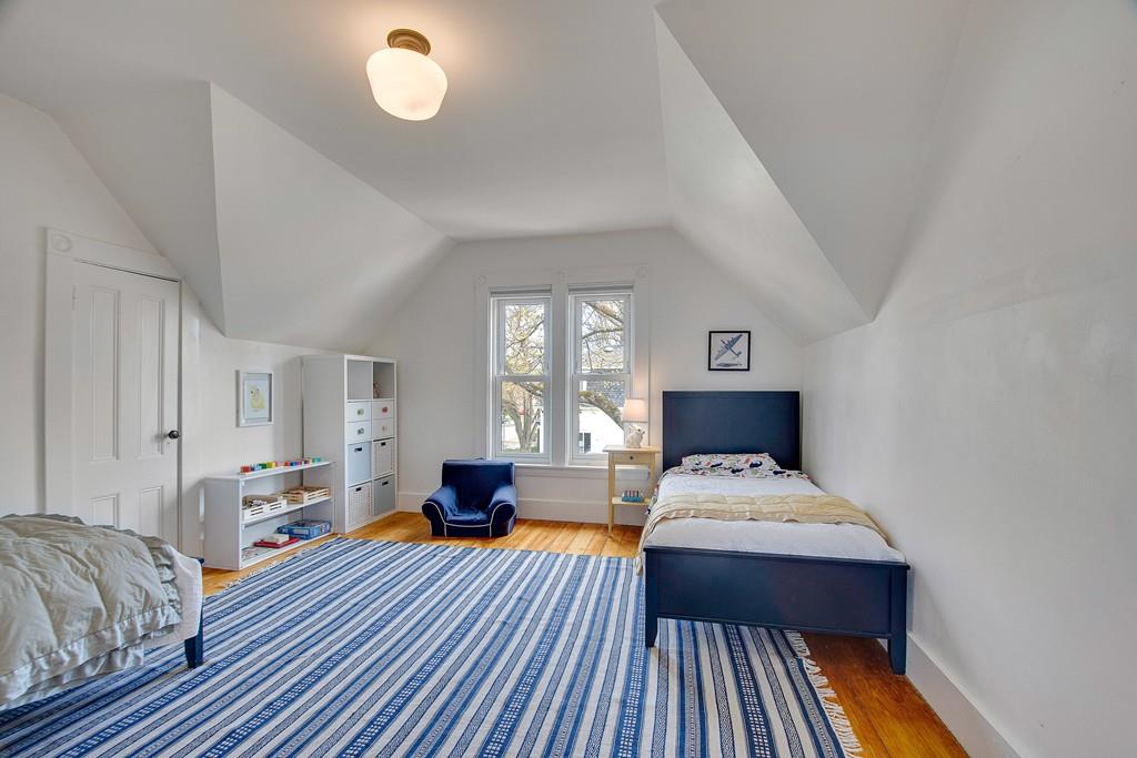 86 Pond Street Natick, MA 01760 - Photo 25 of 33 a bedroom with a bed and wooden floor
