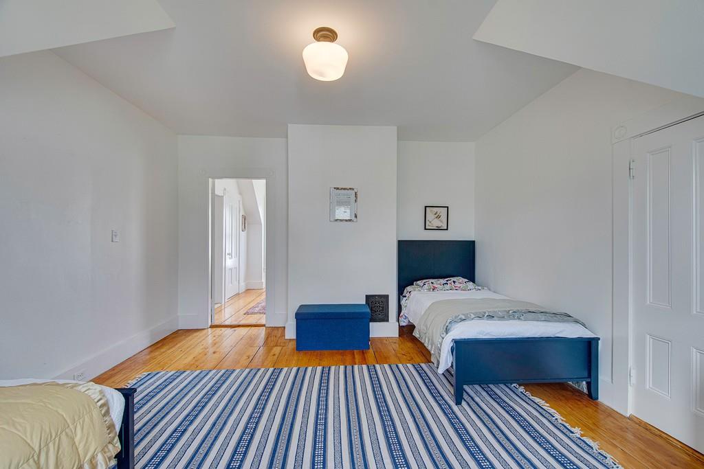 86 Pond Street Natick, MA 01760 - Photo 26 of 33 a bedroom with a bed and wooden floor