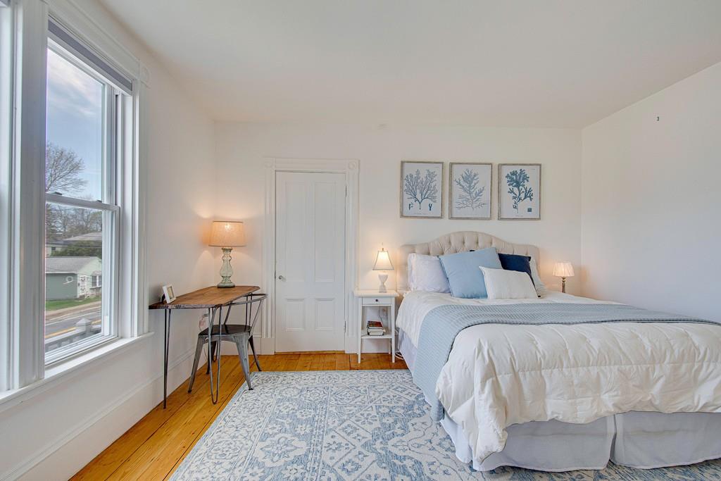 86 Pond Street Natick, MA 01760 - Photo 28 of 33 a bed room with a bed and a chair