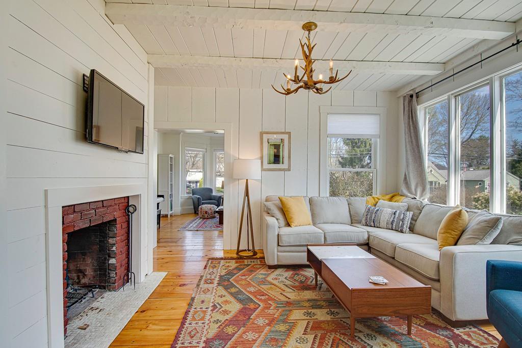 86 Pond Street Natick, MA 01760 - Photo 9 of 33 a living room with furniture a fireplace and a flat screen tv