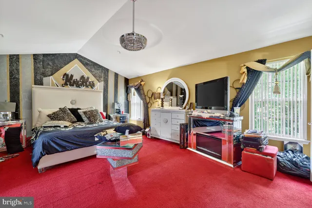 a living room with furniture gym equipment and a large window