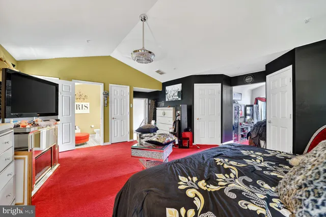 a bedroom with bed and flat screen tv