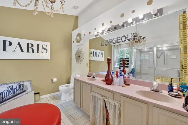 a bathroom with a sink mirror and toilet