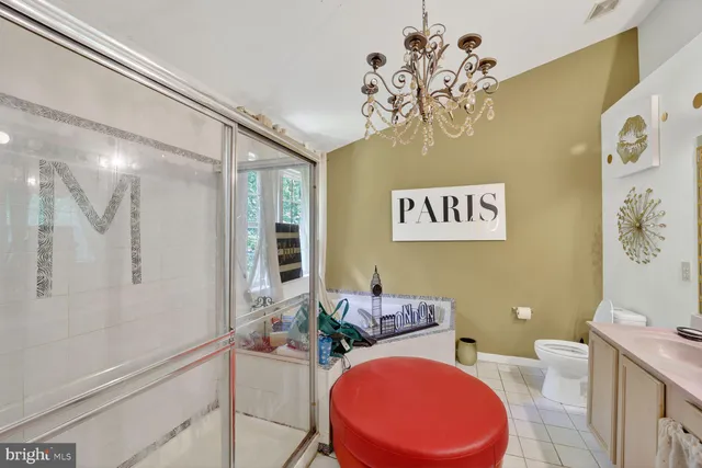 a bathroom with a sink a mirror a toilet and a shower