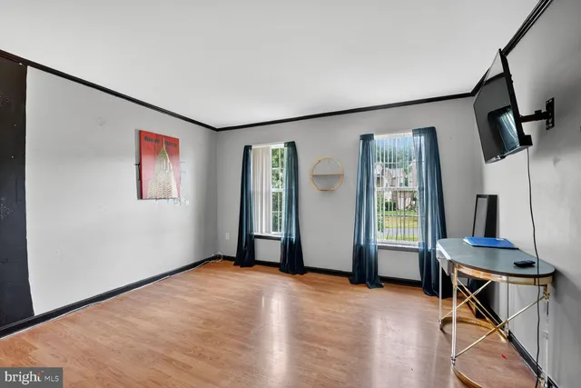a view of livingroom with hardwood floor and workspace