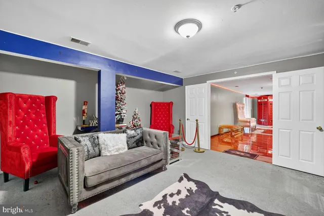 a living room with furniture and a lamp