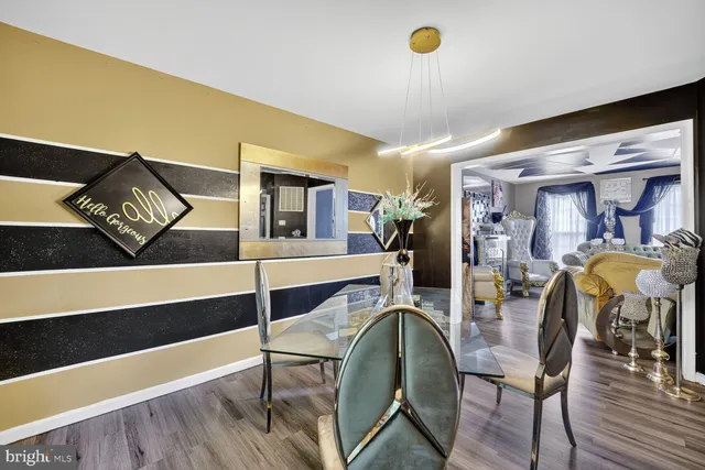 a dining room with furniture and wooden floor