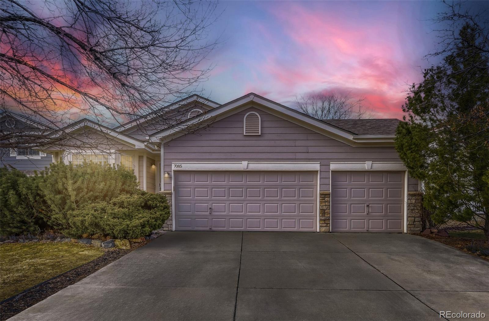 7085 Leopard Gate Lone Tree, CO 80124 - Photo 1 of 26 a front view of a house with a garage
