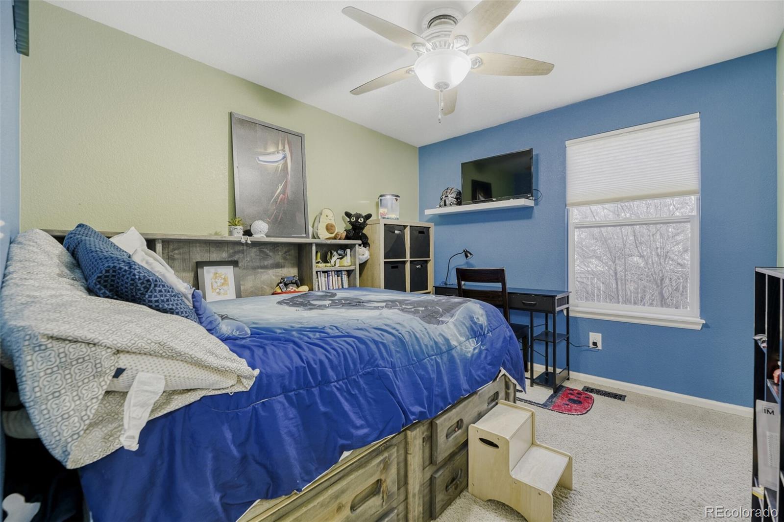 7085 Leopard Gate Lone Tree, CO 80124 - Photo 15 of 26 a bed room with a bed window and a chair