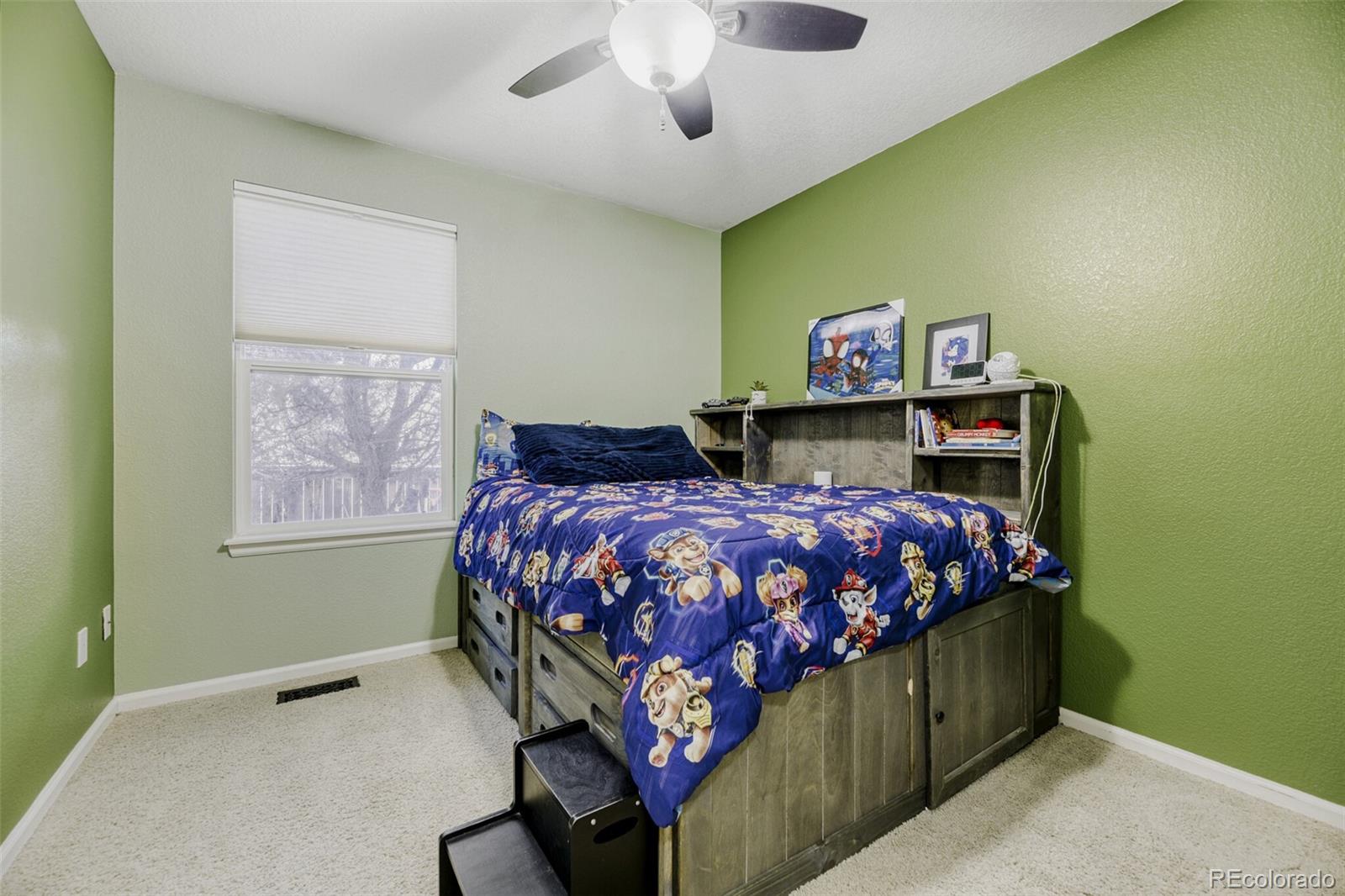 7085 Leopard Gate Lone Tree, CO 80124 - Photo 16 of 26 a bedroom with a bed and a chandelier