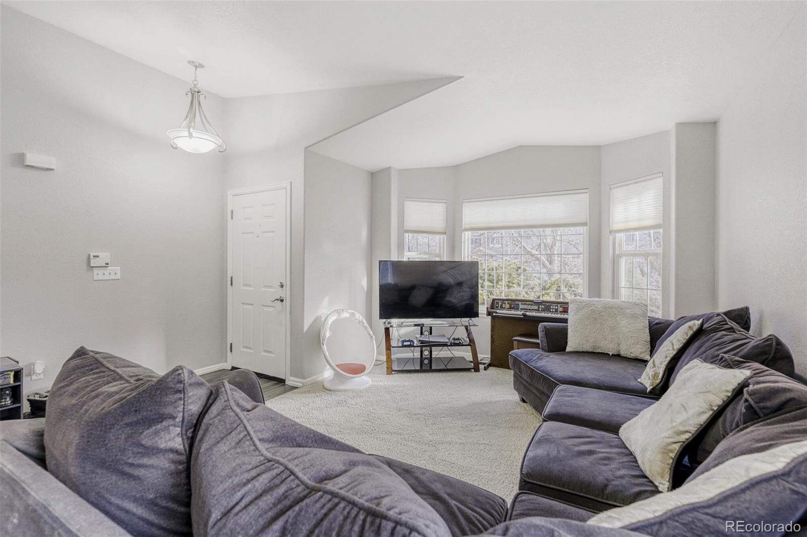 7085 Leopard Gate Lone Tree, CO 80124 - Photo 2 of 26 a bedroom with furniture and a flat screen tv