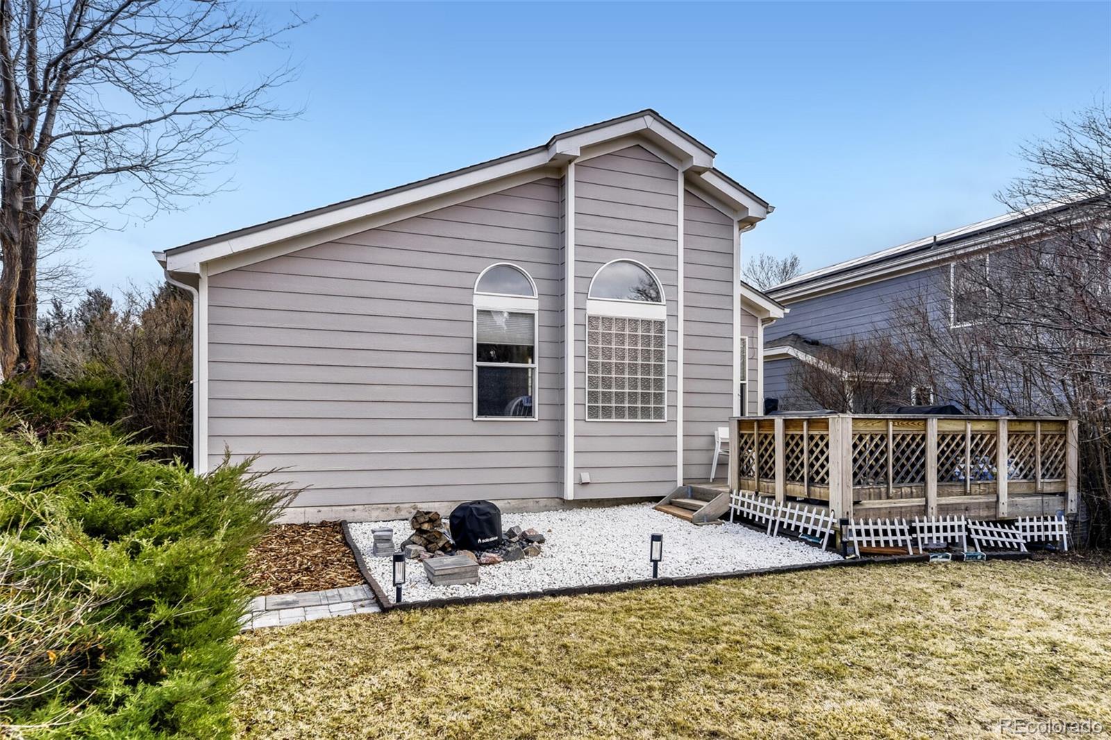 7085 Leopard Gate Lone Tree, CO 80124 - Photo 23 of 26 a view of a house with backyard and sitting area