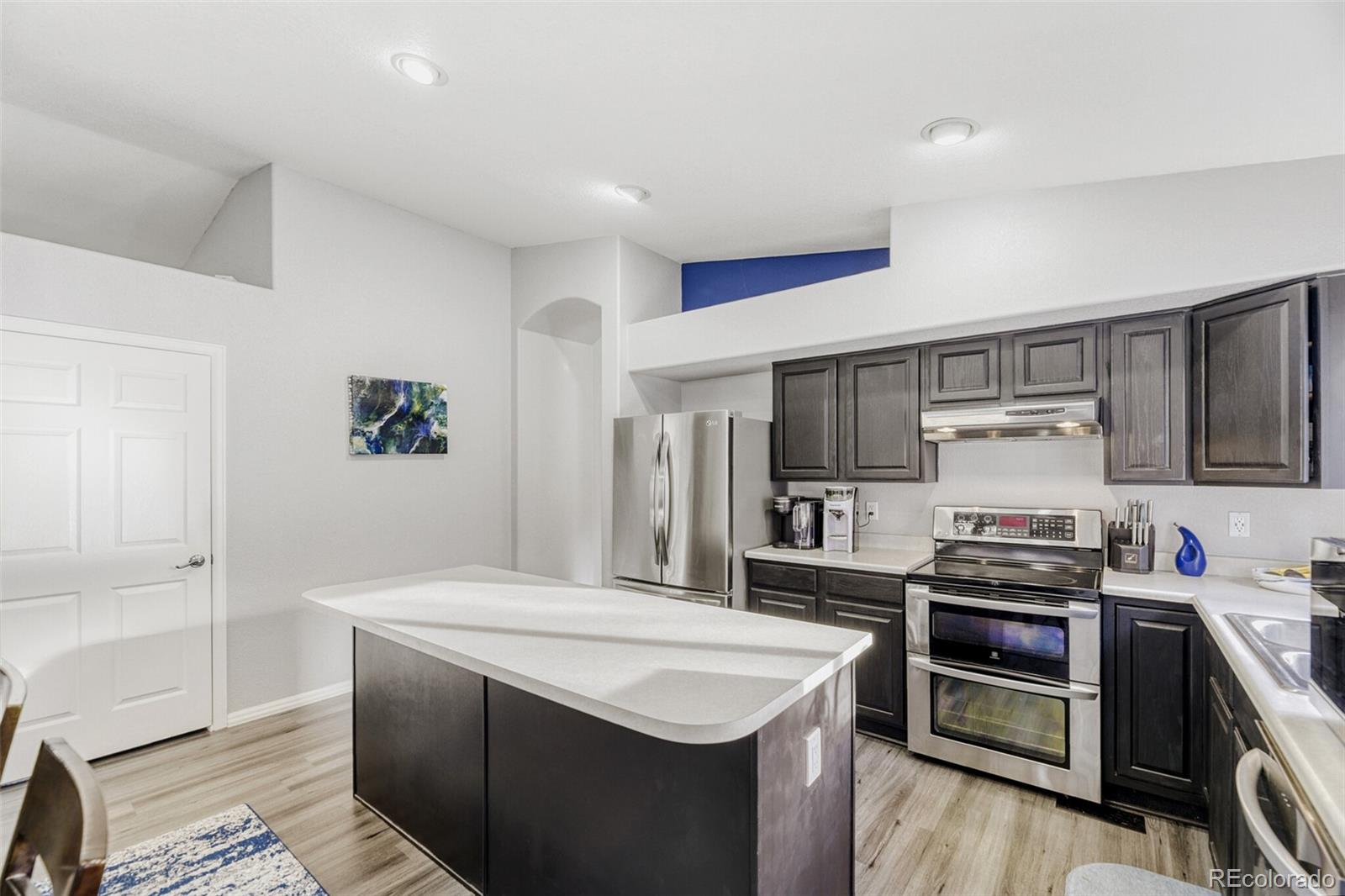 7085 Leopard Gate Lone Tree, CO 80124 - Photo 5 of 26 a kitchen with a sink stainless steel appliances and cabinets