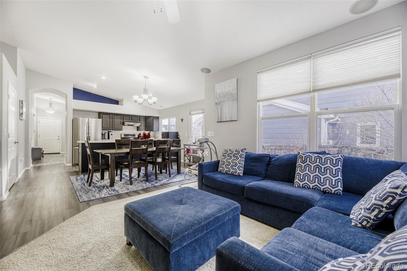 7085 Leopard Gate Lone Tree, CO 80124 - Photo 8 of 26 a living room with furniture and wooden floor