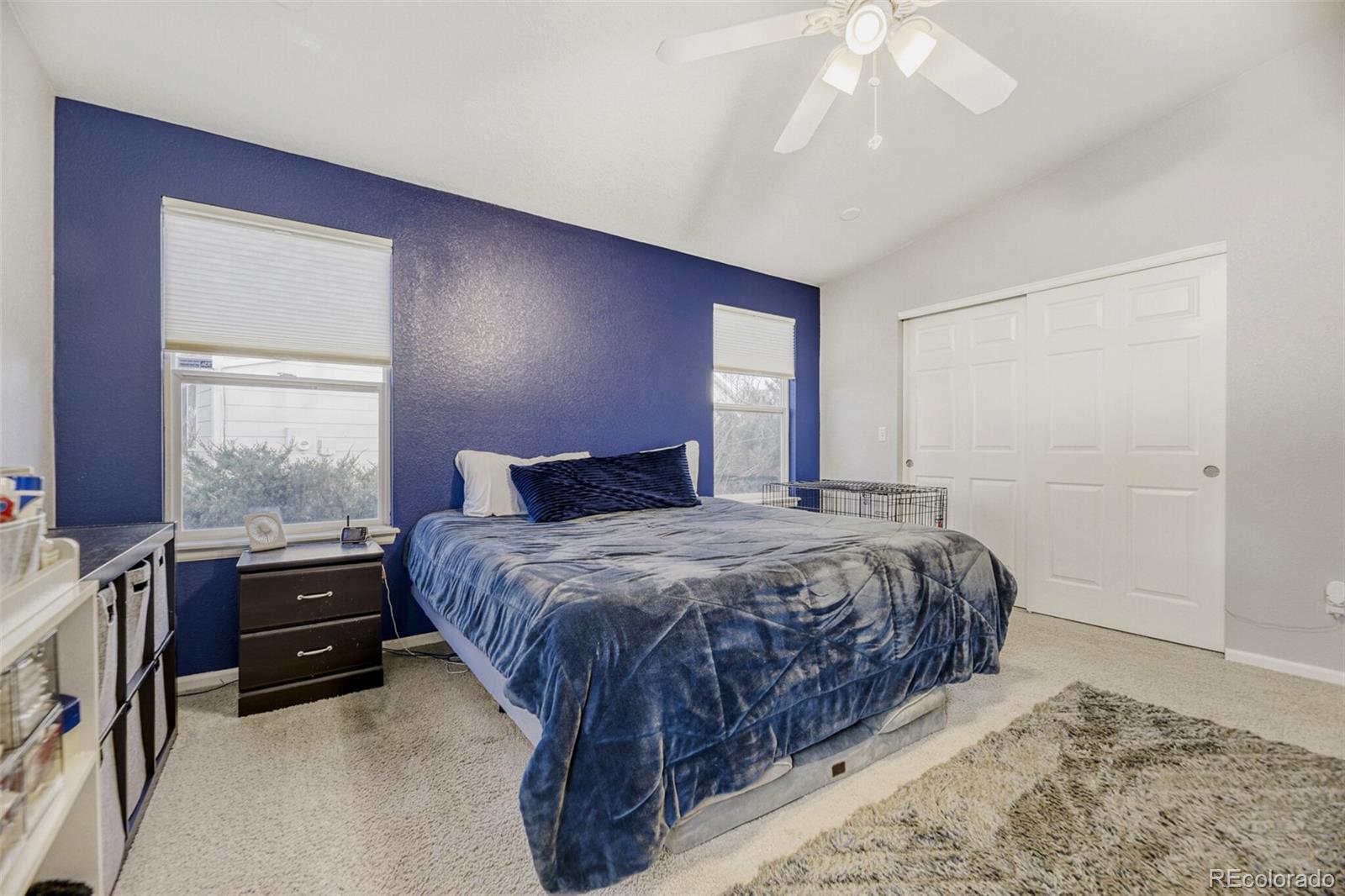 7085 Leopard Gate Lone Tree, CO 80124 - Photo 10 of 26 a bedroom with a bed and window